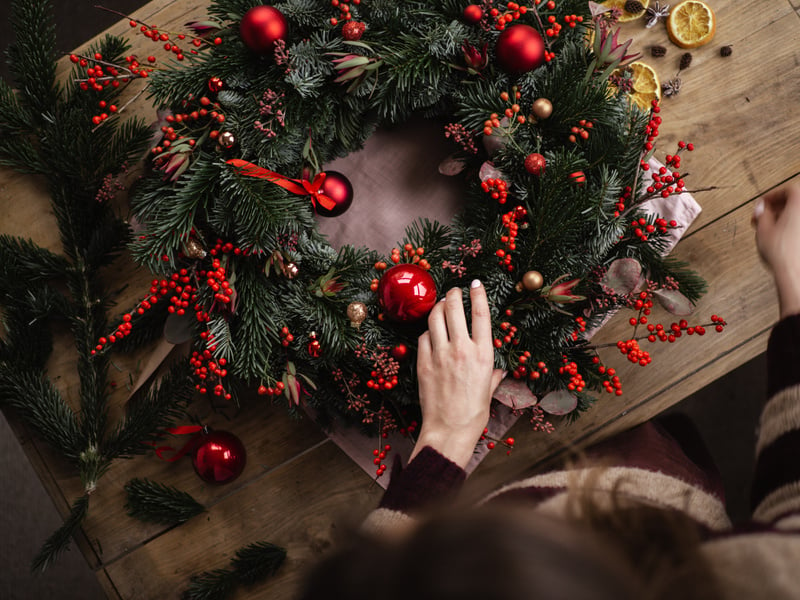 Person Making Christmas Wreath